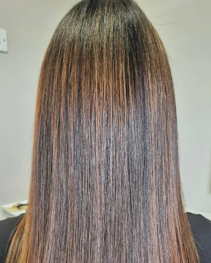The same hair straightened, with visible copper tones